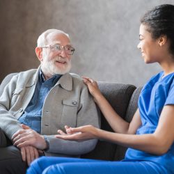 Caring,African american,Nurse,Talks,To,Old,Elderly,Senior,Patient,Holds